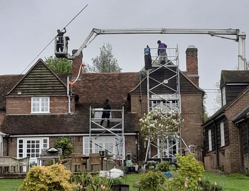 The Roof Moss Cleaners using cherry picker and scaffolding to clean roof safely and professionally in Tring, Hertfordshire